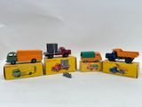 five toy trucks sitting in a row on top of each other