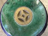 a green and yellow plate with a star on it