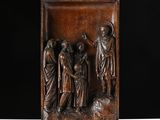a bronze plaque depicting a group of people in a landscape