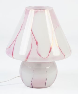a white lamp with a pink shade on top of it