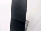 a phone that is sitting on a stand on a table