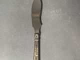 a silver spoon and a knife on a table