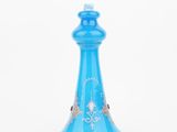 a blue glass perfume bottle on a white background