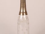 an image of a glass bottle with a gold top on a white background