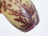 a hand holding a vase with a design on it