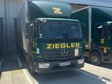 two trucks that are parked next to each other in a parking lot