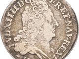 gros plan d'une pièce de monnaie sur laquelle figure une tête de femme
