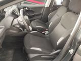the interior of a car with black leather seats and a red car in the background
