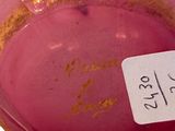 a close up of a pink bowl with a label on it