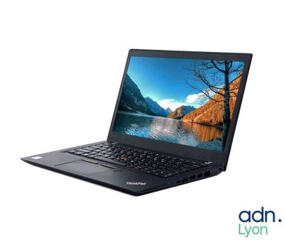 a laptop with a picture of a lake on the screen