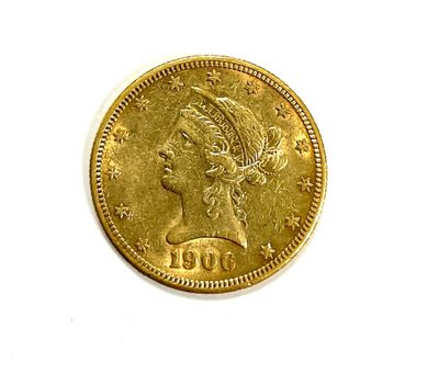 a close up of a gold coin on a white surface