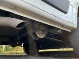 a close up view of a car ' s exhaust pipe and exhaust muffler