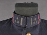 an image of a military uniform with a red stripe on the collar