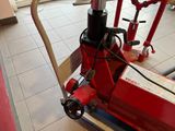 a red machine that is sitting on the floor