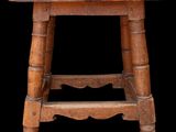 an old wooden stool with a black background