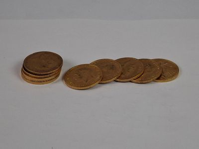 a pile of coins sitting on a table next to a pile of coins