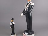 two figurines of a man in uniform and a woman in uniform
