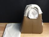 the bag is sitting on the table next to the cloth