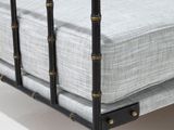a bed with a metal frame and a mattress on it
