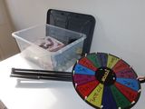 a wheel of fortune on a table next to a pair of chopsticks