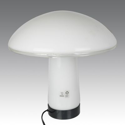 a white mushroom shaped lamp with a black base