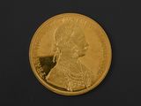 an image of a close up of a gold coin on a black surface