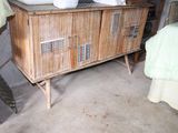 a wooden cabinet with two sinks and a mirror