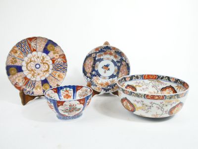 four different types of japanese plates and bowls on a white surface