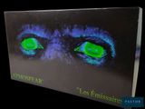 an image of a book with green eyes and a black background