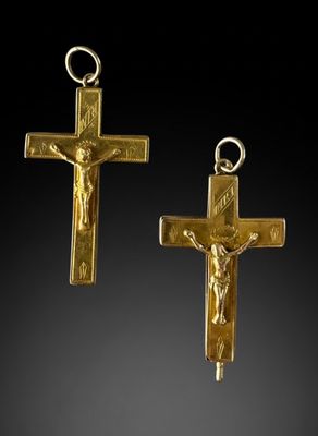 two gold cross pendants with jesus on the cross
