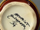 a close up of a vase with writing on it