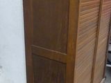 a wooden cabinet with a door on top of it