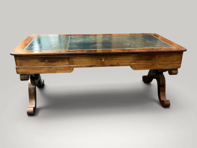 a wooden table with a glass top on wheels