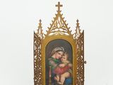 an old picture frame with a picture of a child and a cross