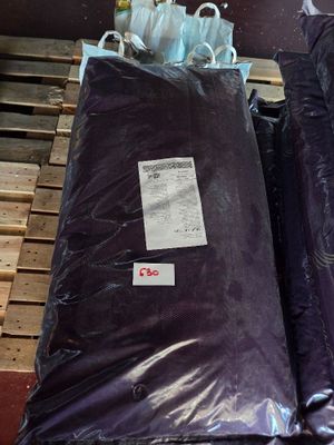 two bags of purple bags sitting on top of a pallet