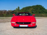 a red sports car parked in a parking lot