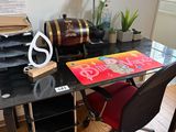 a black desk with a red chair in front of it