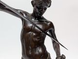 bronze statue of a man holding a knife and a sword