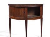 an oval walnut side table with a shelf on one side and a drawer on the other