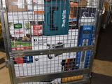 a metal cart with many items in it in a warehouse