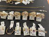 many different types of jewelry on display on a table