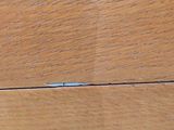 a toothbrush sitting on a wooden table next to a pair of scissors