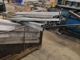 many pieces of metal in a metal cage in a warehouse