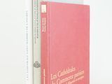 two books sitting on top of each other on a white surface