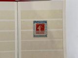 a red book with a stamp on it sitting on a table