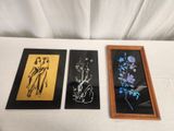 three framed pictures of flowers on a table with a white table cloth