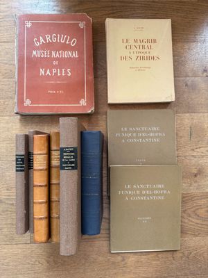 several books are sitting on a table next to each other