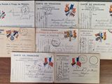 several old french postcards on a wooden table with a clock