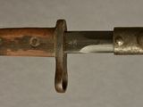 a close up of a knife with a wooden handle