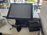 a computer and a printer on a table in a restaurant